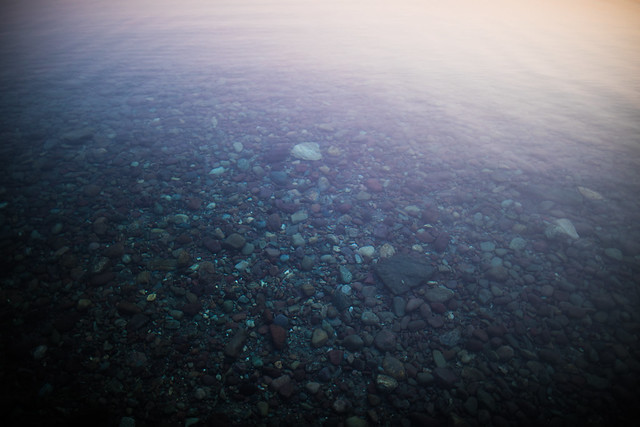 Stones beneath the clear, shallow water of Lake McDonald