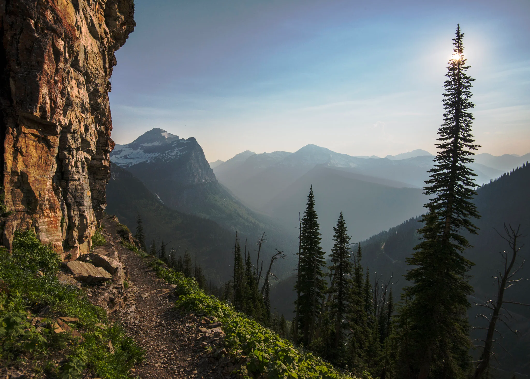 Hikers on the Garden Wall Highline Trail with sweeping alpine ridge views in Glacier National Park in summer