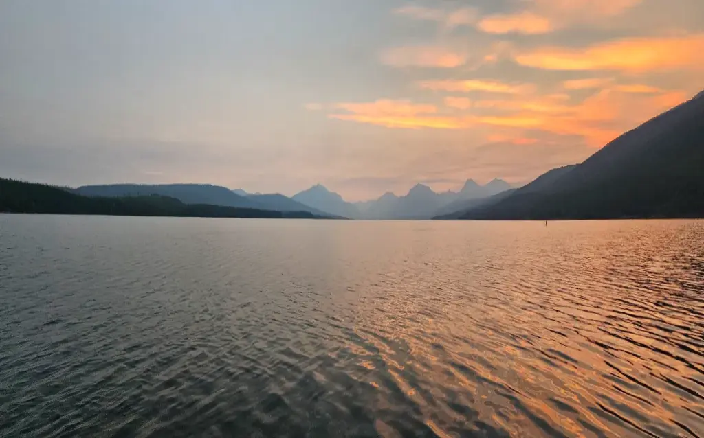 Lake McDonald at sunrise in Glacier National Park, where ranger-narrated boat tours depart at 1:30 PM and 3:00 PM