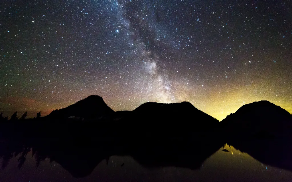 Clear night sky over Logan Pass in Glacier National Park showing stars and Milky Way