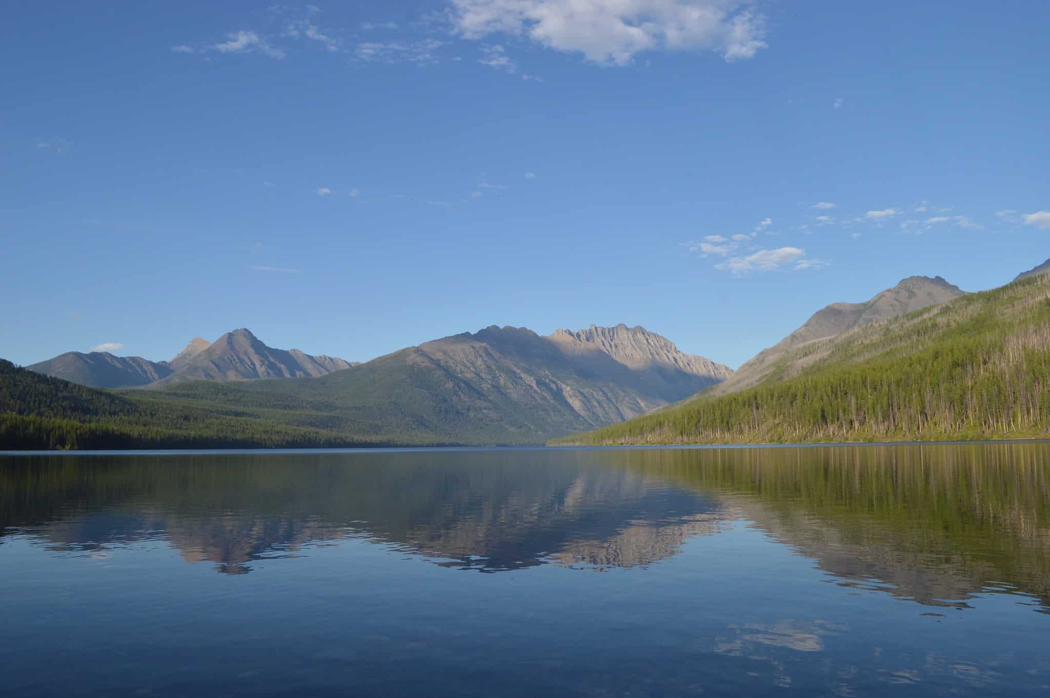 Kintla Lake surrounded by forest and mountains in Glacier National Park's remote North Fork area