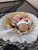 Chocolate ice cream sundae in a waffle bowl with whipped cream, sprinkles, and a cherry in Yellowstone National Park.