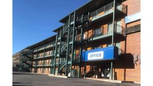Exterior view of a modern hotel facade with a covered entrance and landscaped grounds