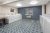 Laundromat in a Yellowstone National Park lodge, with row of washers and dryers against a blue wall.