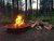 Campfire ring with stacked logs at Sundance Campground in Glacier National Park.