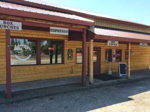 Storefront exterior with doorway, awning, and bakery signage
