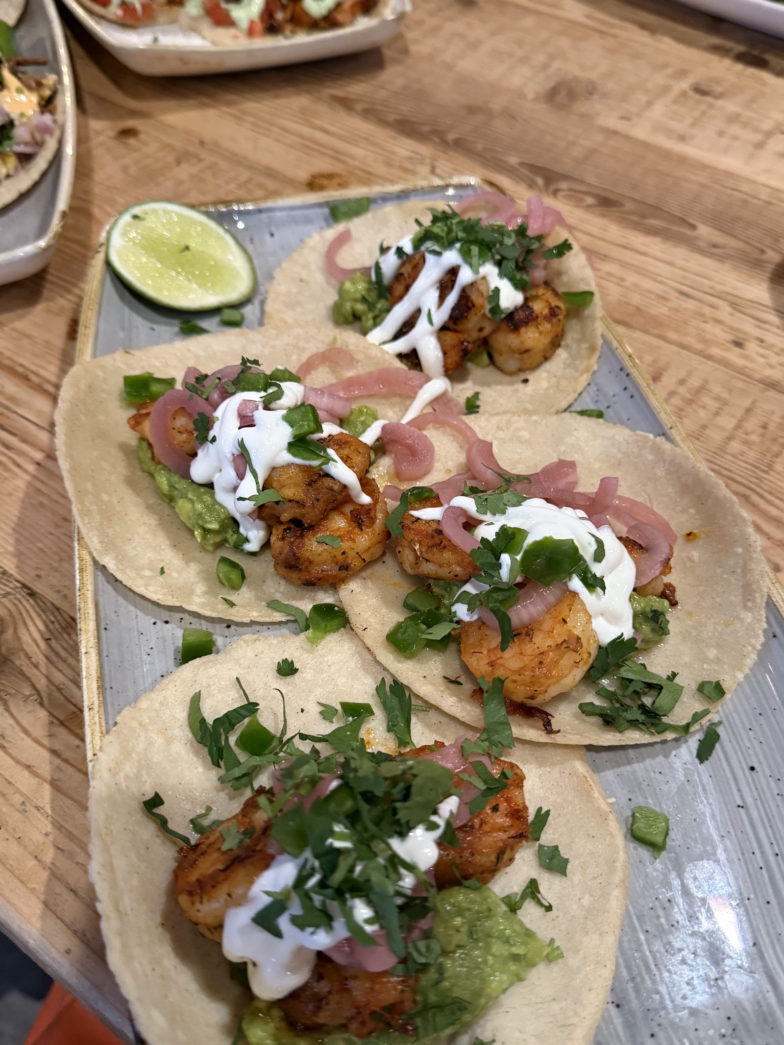 Shrimp tacos with guacamole, crema, pickled onions and cilantro on warm corn tortillas in Glacier National Park.
