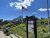 Logan Pass Visitor Center at Glacier National Park stands beside a flagpole with the American flag under a bright blue sky.