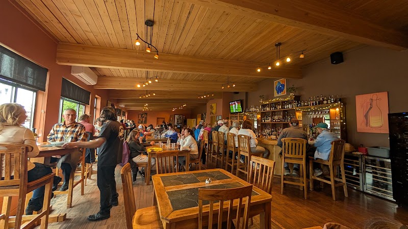 Interior dining area in a Yellowstone National Park lodge with wooden beams and visitors.