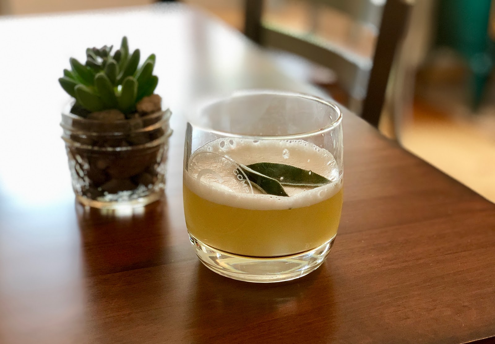Beer in a glass on a wooden table inside Glacier National Park dining venue.