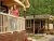 Couple on the porch of a wooden lodge at West Glacier Village in Glacier National Park.