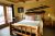 Cozy rustic lodge bedroom in Glacier National Park with a log bed and vintage ski decor on the wall.