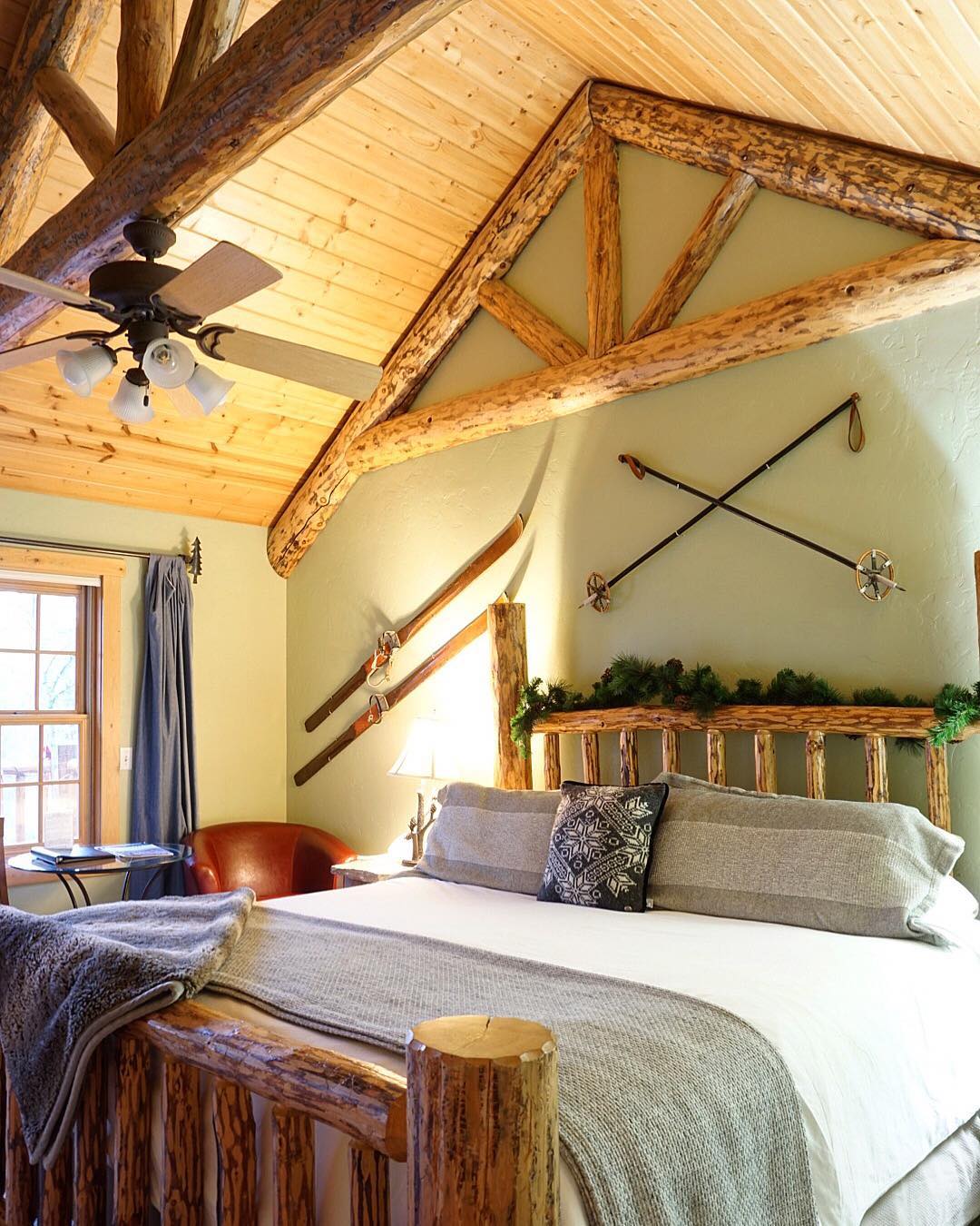 Rustic log-bedroom inside Glacier National Park, with exposed beams and warm decor in a mountain lodge atmosphere.
