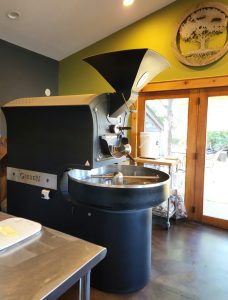 Cafe interior in Glacier National Park featuring an on-site coffee roaster and warm wooden accents.