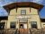 Restaurant storefront in a rustic lodge-style building along a walkway in Glacier National Park.