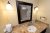 Hotel bathroom vanity and mirror in a Glacier National Park lodging room, granite countertop and bright lighting.