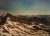 Glacier Peak towers over rugged, snow-dusted ridges in Glacier National Park, Montana.