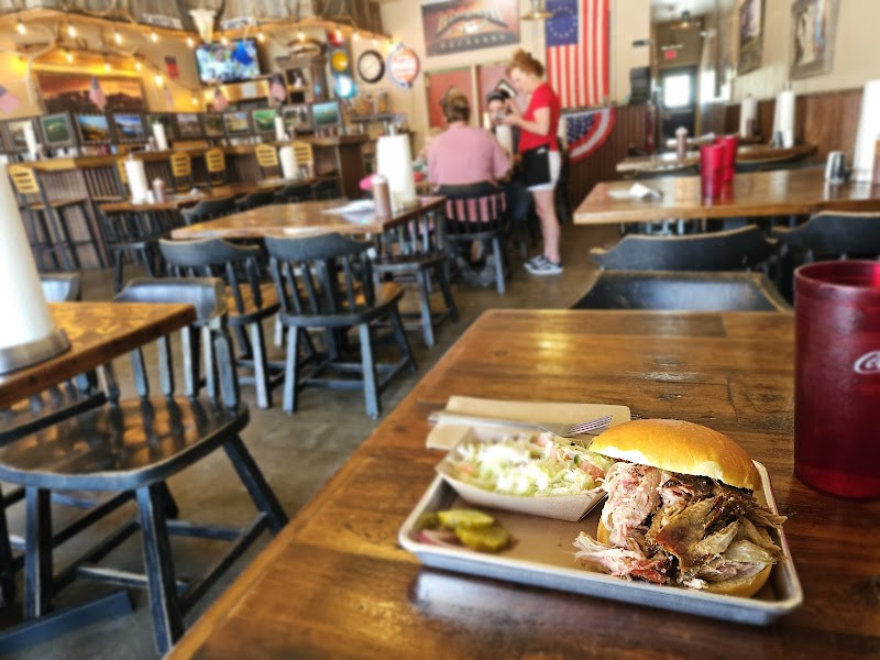 Interior at a Yellowstone National Park barbecue restaurant with a pulled pork sandwich on a tray.