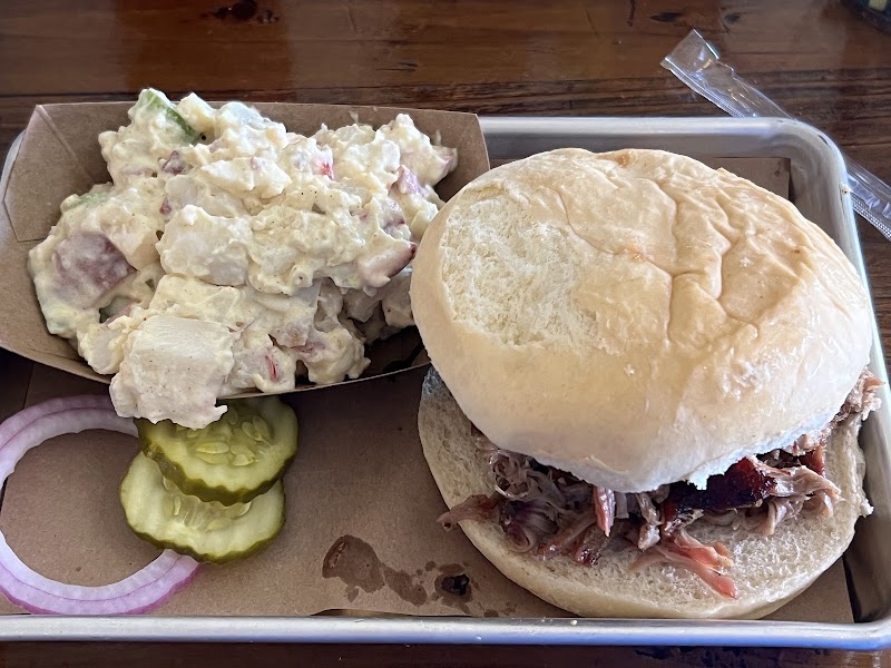 Pulled pork sandwich with slaw and pickles, served at a Yellowstone National Park eatery.