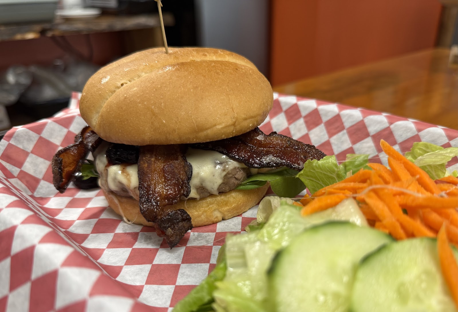 Juicy bacon cheeseburger with melted cheese and greens served at a Glacier National Park eatery.