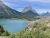 View over Lake McDonald at Glacier National Park, with towering peaks and a forested shoreline under blue skies.