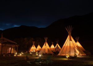 Exterior view of the tipi-inspired lodge entrance with natural landscaping