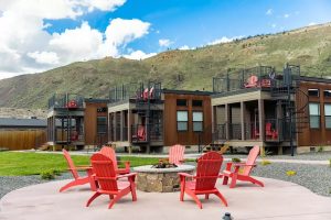 Exterior view of a mountain-lodge style hotel with wooden siding and large windows