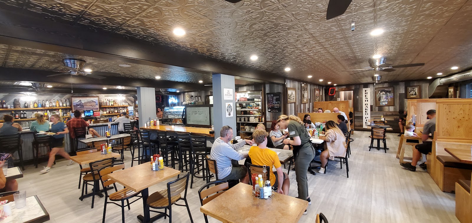 Inside Eddie's Mercantile in Glacier National Park, patrons browse shelves and enjoy casual dining at the counter.