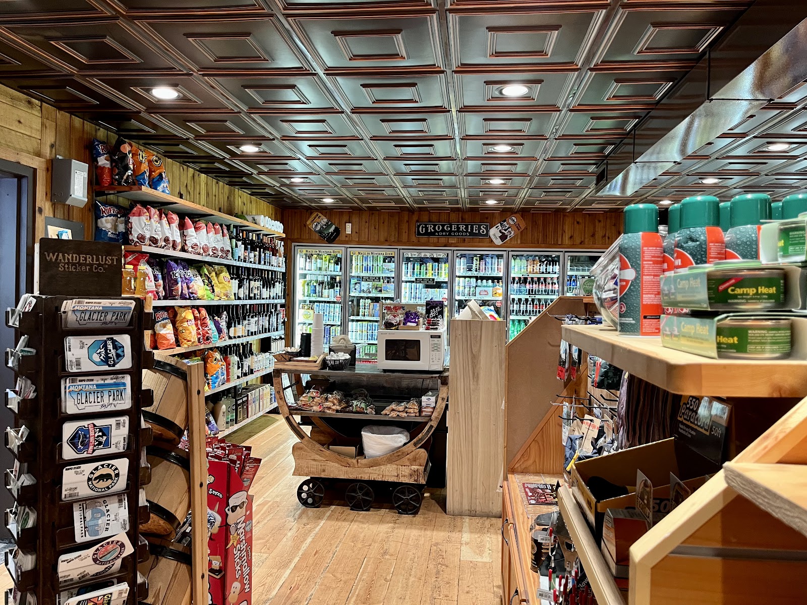 Gift shop interior at Glacier National Park, stocked with snacks, souvenirs, and camping supplies.