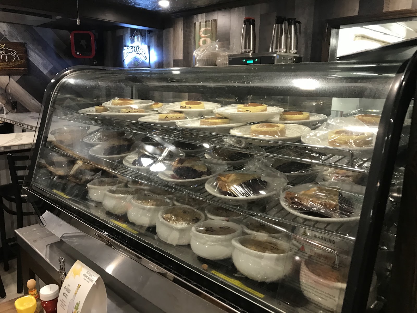 Assorted pastries on display inside a Glacier National Park gift shop case, showcasing baked goods for visitors.