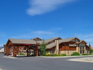 Timber-clad lodge exterior with stone accents and a welcoming entry