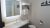 Lodge bathroom with illuminated mirror and towel rack inside Yellowstone National Park accommodation.