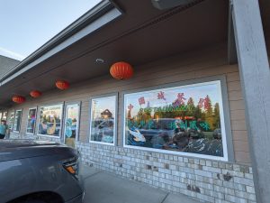 Glacier National Park storefront restaurant with red lanterns and colorful window signs along the building
