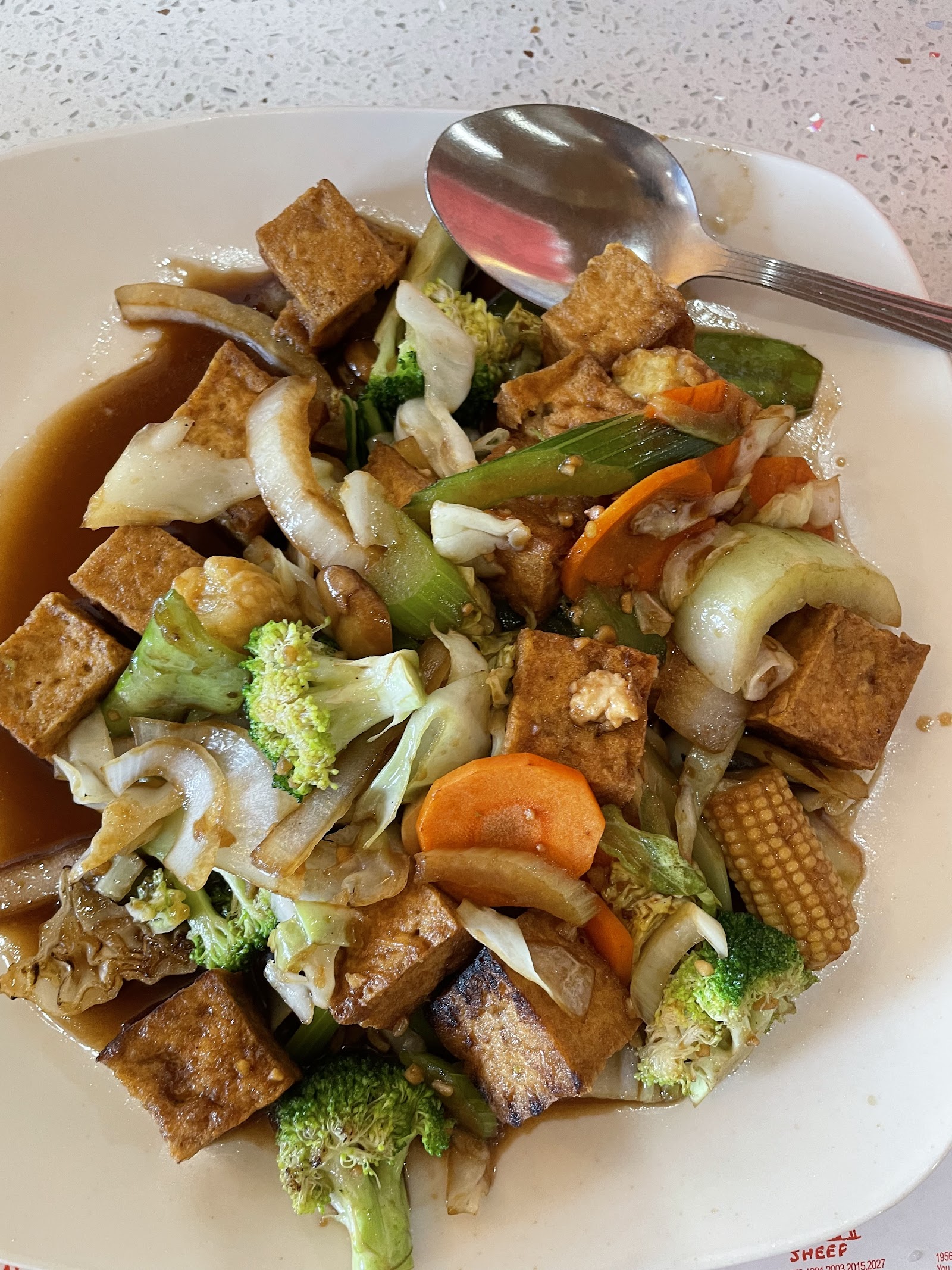Tofu and vegetable stir-fry with broccoli, carrots, and onions served at Glacier National Park restaurant