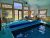 Indoor pool at a lodge in Yellowstone National Park, with large windows and mountain views behind the pool area.