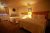 Yellowstone-area lodge room with two queen beds in Yellowstone National Park, cozy lighting and wooden headboards.