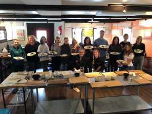 Group of diners at a Glacier National Park sushi restaurant posing with plated dishes