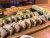 Assorted sushi rolls arranged on a wooden board at a Glacier National Park restaurant, ready for sharing.