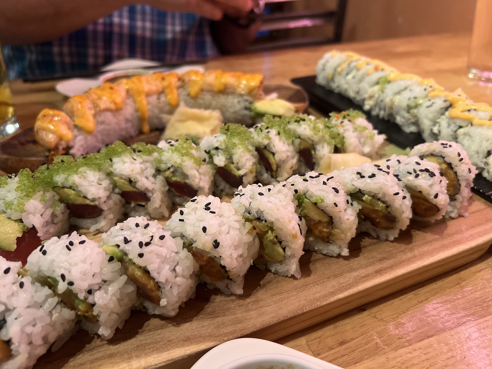 Assorted sushi rolls arranged on a wooden board at a Glacier National Park restaurant, ready for sharing.