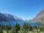 Broad blue Lake McDonald framed by rugged glacier-carved peaks and evergreen forest, Glacier National Park.