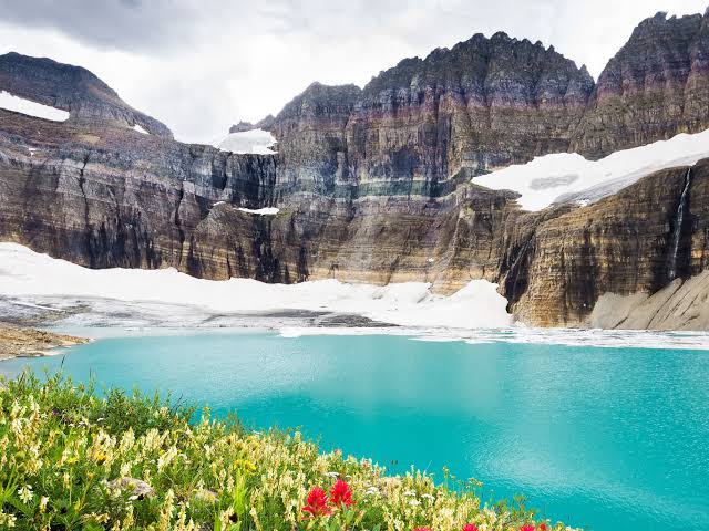 Station 8 at Glacier National Park overlooks a turquoise alpine lake with snow-capped peaks in the distance.