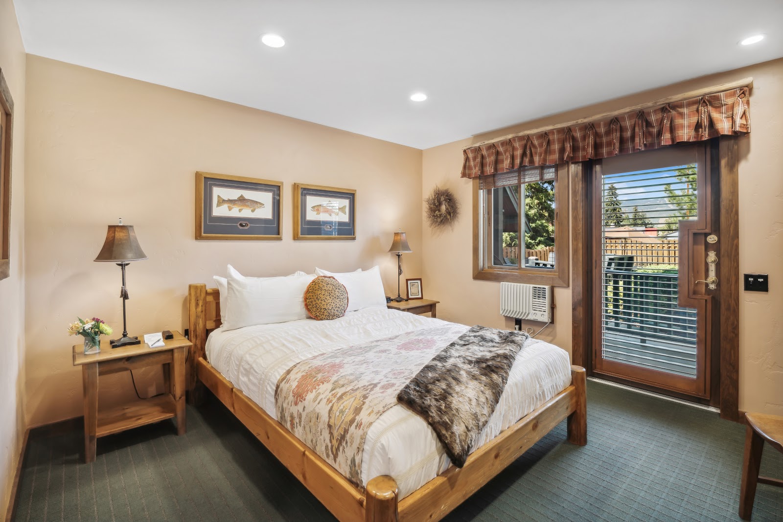 Cozy lodge bedroom with a wooden bed frame and warm lighting in Glacier National Park.