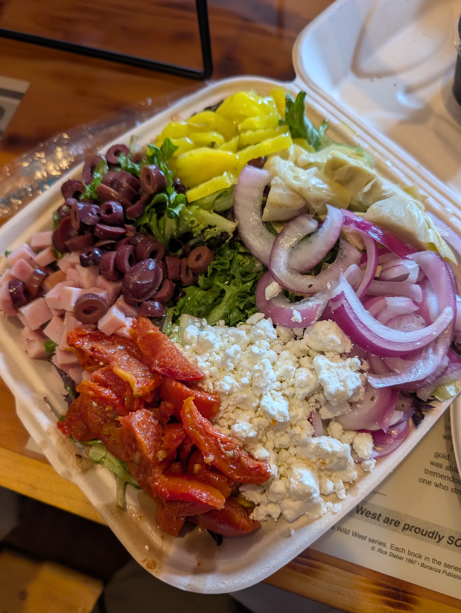 Colorful salad plate with olives, feta, red onions and peppers at a Glacier National Park dining spot.