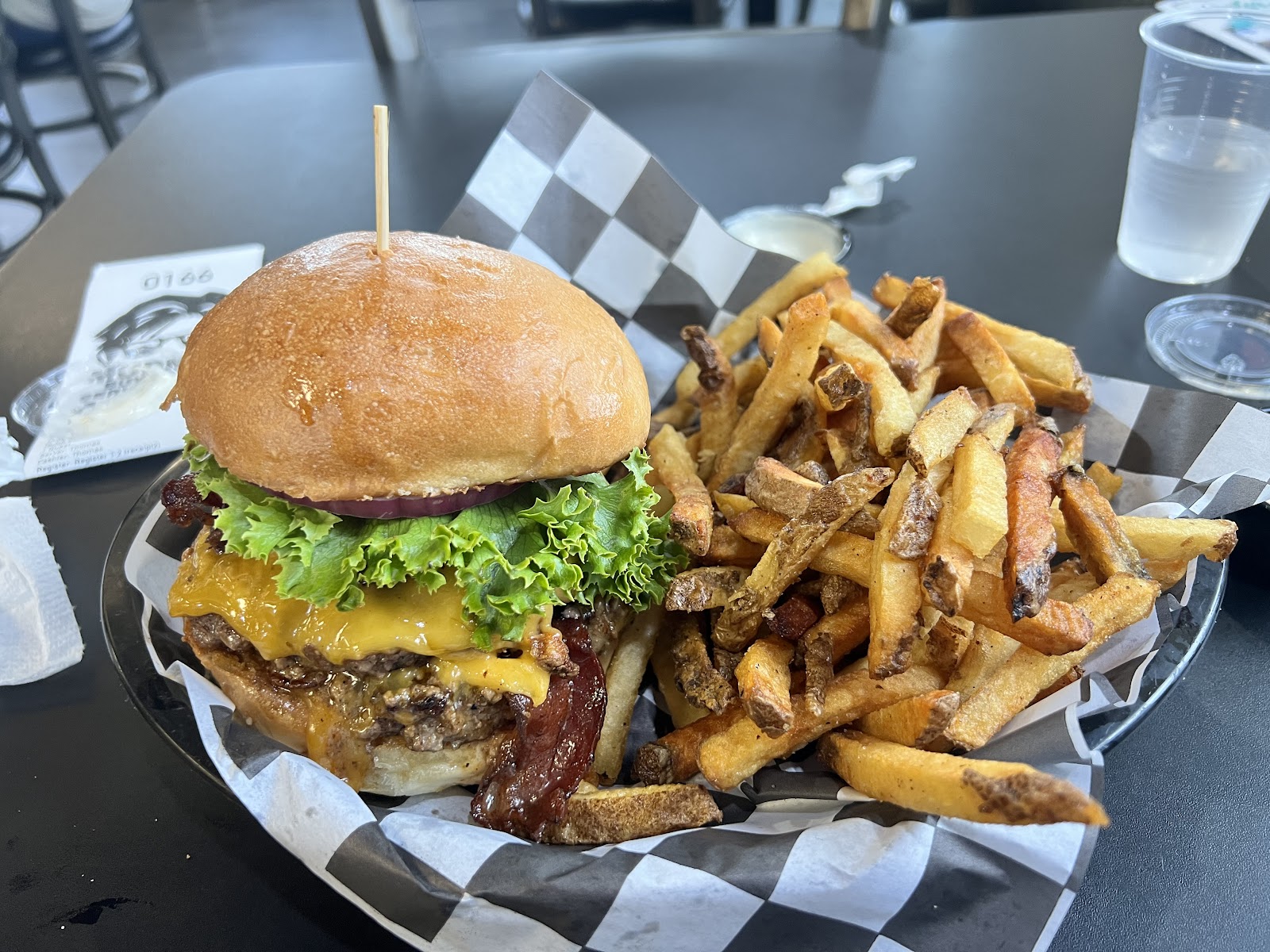 Cheeseburger with lettuce and onions and a generous serving of fries in a Glacier National Park eatery.