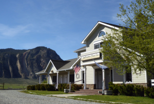 Front facade with rustic wood siding and welcoming porch.