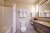 Interior hotel bathroom at Yellowstone National Park with a tub/shower, toilet, and neatly folded towels.
