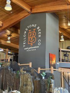 Rustic storefront with wooden sign and large windows