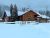 Exterior of a rustic wooden restaurant in the Polebridge area of Glacier National Park, snow-covered and quiet.