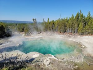 Exterior view of the trailhead building with rustic wooden signage and trail map