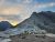 Bear's Hump Trailhead at Glacier National Park features rugged limestone ridges with a sunset glow over the rocky overlook.
